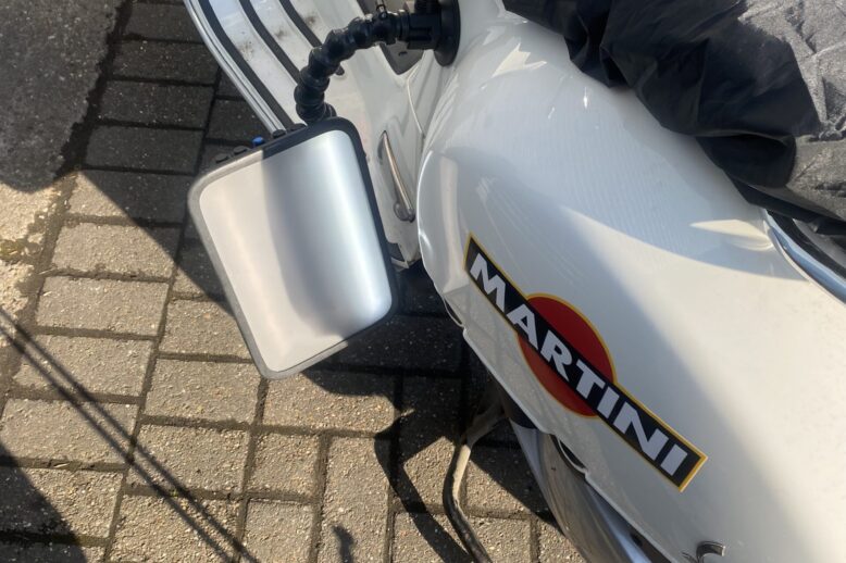 Paintless dent removal on Vespa side panel with reflection board – scooter dent repair in Nottingham and Derby